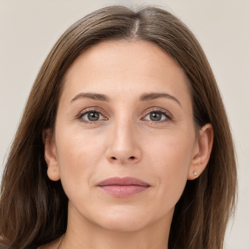 Joyful white adult female with long  brown hair and grey eyes