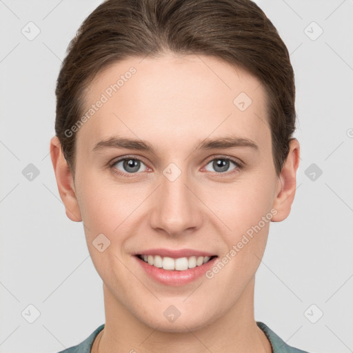 Joyful white young-adult female with short  brown hair and grey eyes