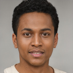 Joyful latino young-adult male with short  brown hair and brown eyes