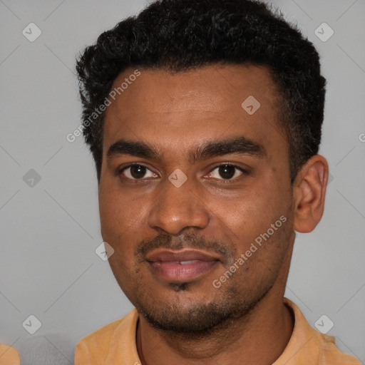 Joyful black young-adult male with short  black hair and brown eyes