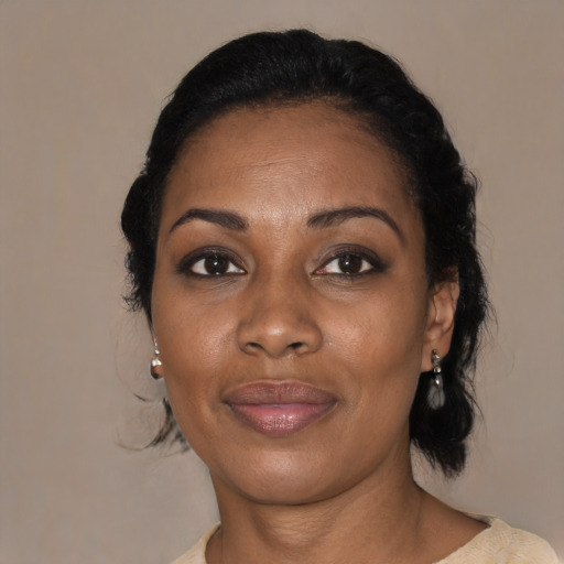 Joyful black adult female with medium  black hair and brown eyes