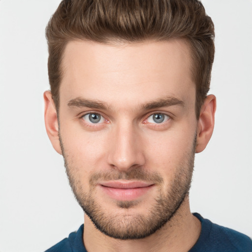 Joyful white young-adult male with short  brown hair and grey eyes