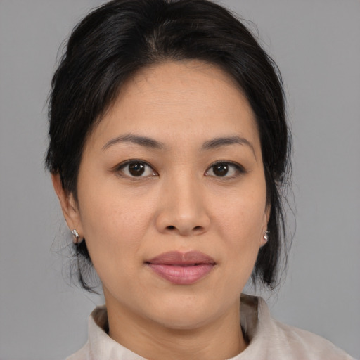 Joyful asian young-adult female with medium  black hair and brown eyes