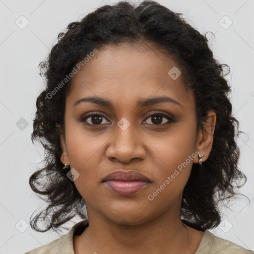 Joyful black young-adult female with long  brown hair and brown eyes