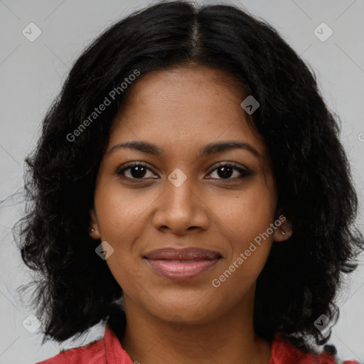 Joyful black young-adult female with long  black hair and brown eyes