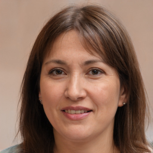 Joyful white adult female with medium  brown hair and brown eyes