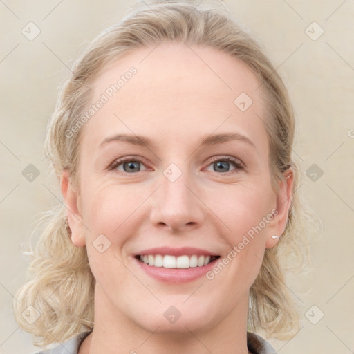 Joyful white young-adult female with medium  brown hair and blue eyes