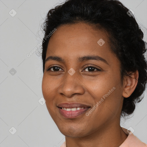 Joyful black young-adult female with short  black hair and brown eyes