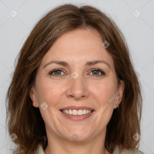 Joyful white adult female with medium  brown hair and grey eyes