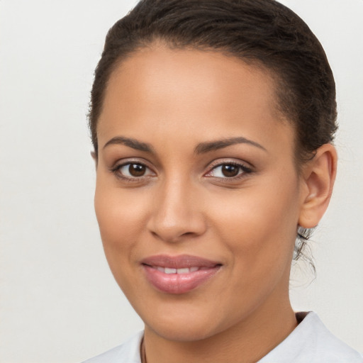 Joyful latino young-adult female with long  brown hair and brown eyes