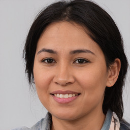 Joyful latino young-adult female with medium  brown hair and brown eyes