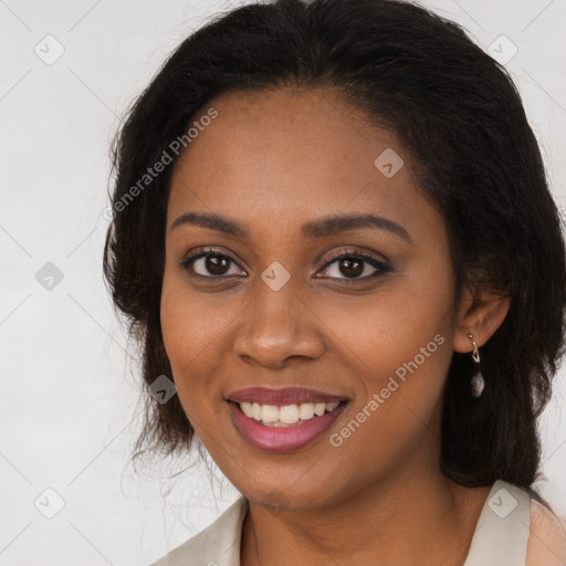 Joyful black young-adult female with long  brown hair and brown eyes