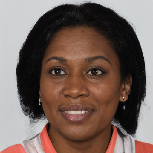 Joyful black adult female with medium  black hair and brown eyes