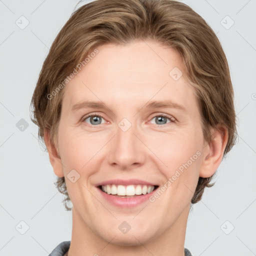 Joyful white young-adult female with short  brown hair and grey eyes