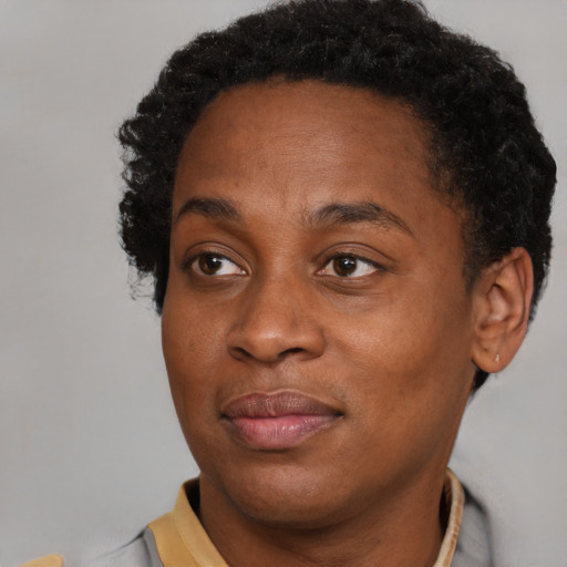 Joyful black adult female with short  brown hair and brown eyes