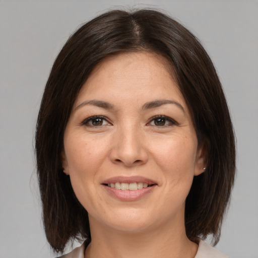 Joyful white adult female with medium  brown hair and brown eyes