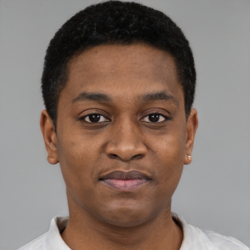 Joyful black young-adult male with short  brown hair and brown eyes