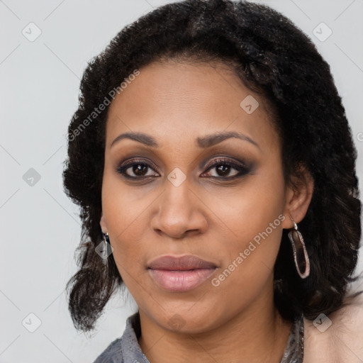 Joyful black young-adult female with long  black hair and brown eyes