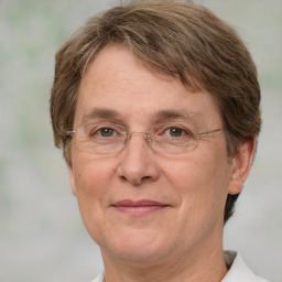 Joyful white middle-aged female with short  brown hair and green eyes