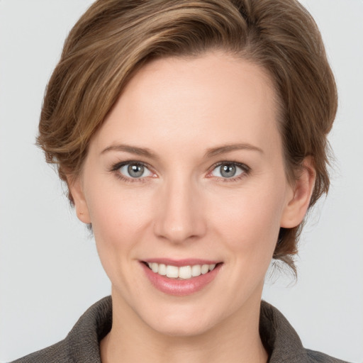 Joyful white young-adult female with medium  brown hair and grey eyes