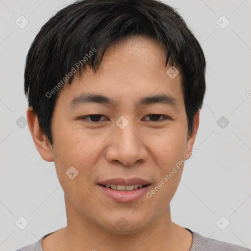 Joyful asian young-adult male with short  brown hair and brown eyes