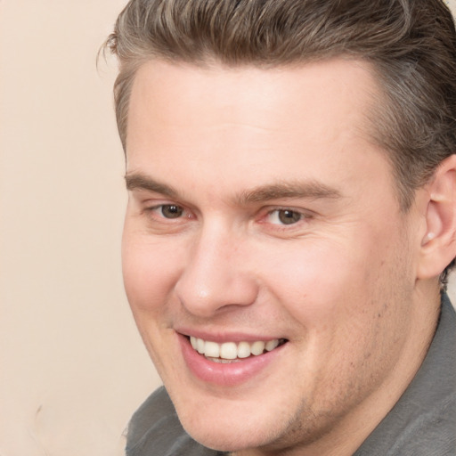 Joyful white adult male with short  brown hair and brown eyes