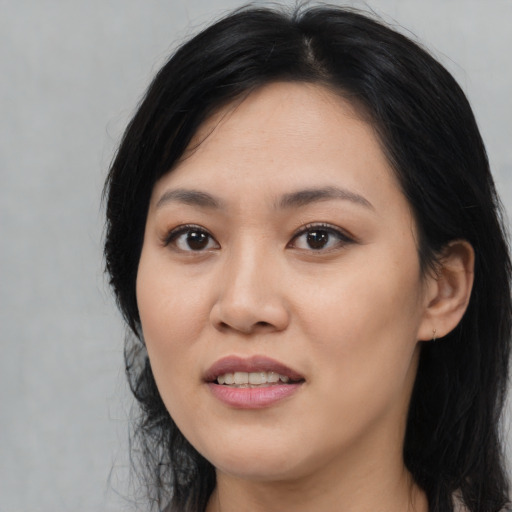 Joyful asian young-adult female with medium  black hair and brown eyes