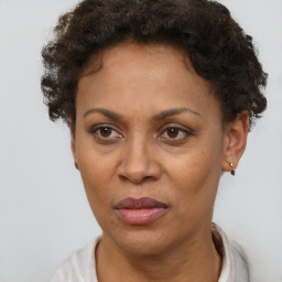 Joyful black adult female with short  brown hair and brown eyes