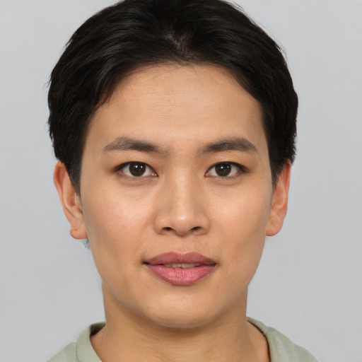 Joyful asian young-adult male with short  brown hair and brown eyes