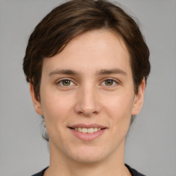 Joyful white young-adult female with short  brown hair and grey eyes