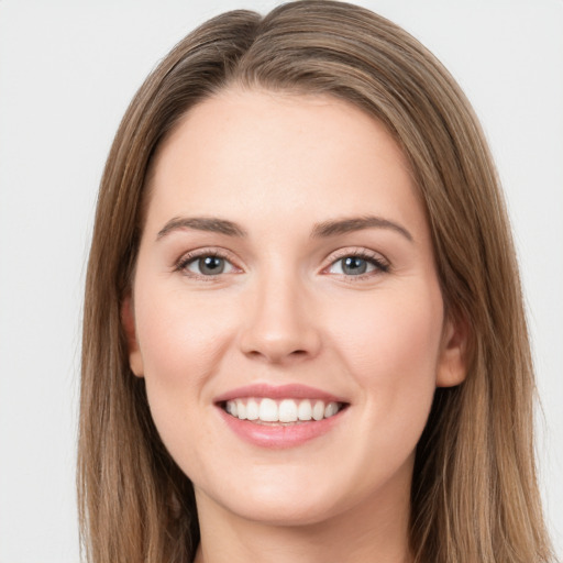 Joyful white young-adult female with long  brown hair and green eyes