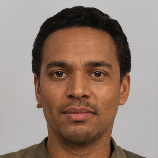 Neutral latino adult male with short  black hair and brown eyes