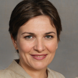 Joyful white adult female with medium  brown hair and grey eyes