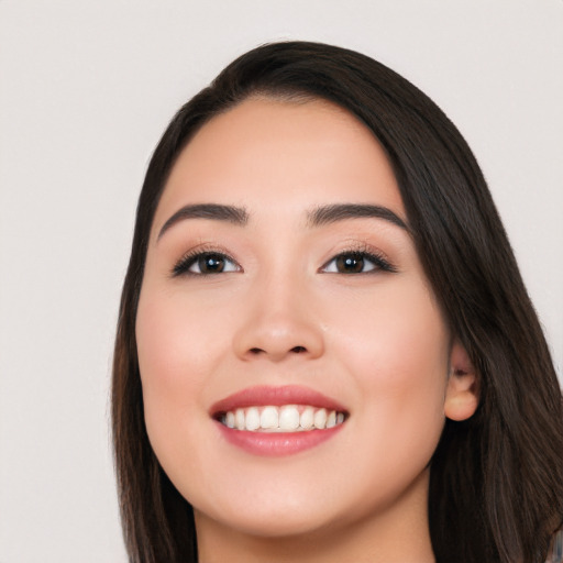 Joyful white young-adult female with long  black hair and brown eyes