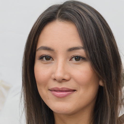 Joyful white young-adult female with long  brown hair and brown eyes