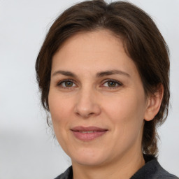 Joyful white adult female with medium  brown hair and brown eyes