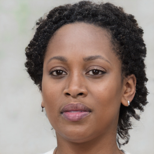 Neutral black young-adult female with medium  brown hair and brown eyes