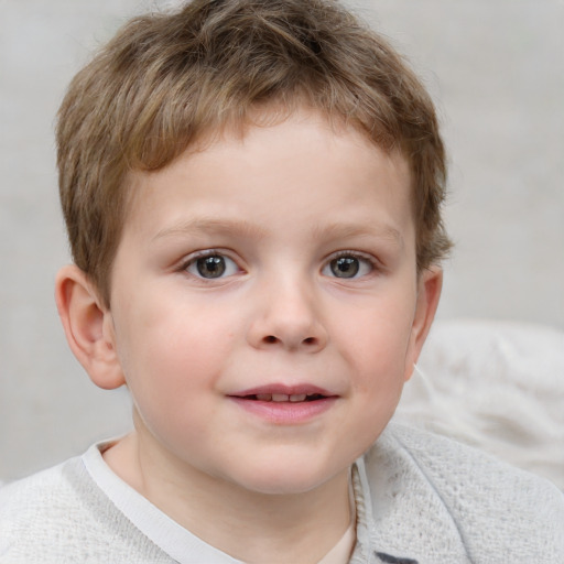 Joyful white child male with short  brown hair and blue eyes