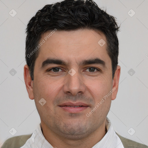 Joyful white young-adult male with short  black hair and brown eyes