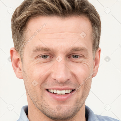 Joyful white adult male with short  brown hair and grey eyes