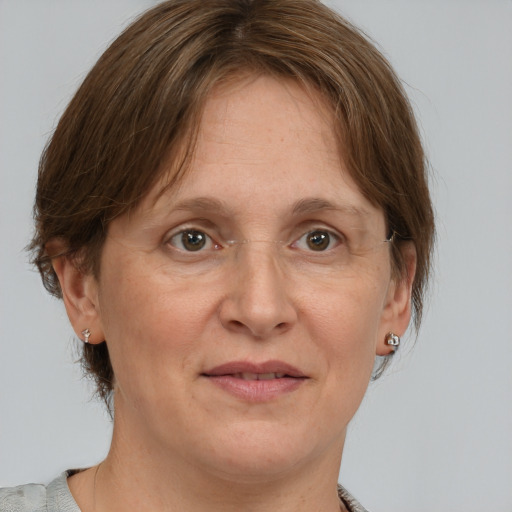 Joyful white adult female with medium  brown hair and grey eyes