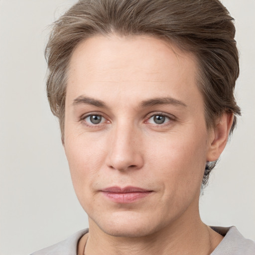 Joyful white young-adult female with short  brown hair and grey eyes