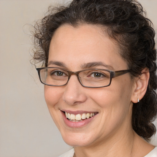 Joyful white adult female with medium  brown hair and brown eyes