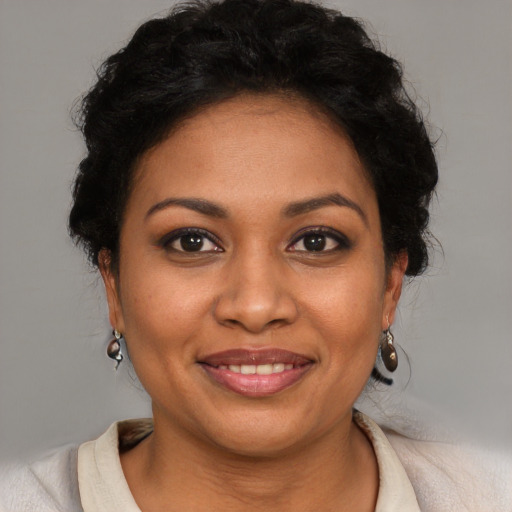 Joyful latino young-adult female with short  brown hair and brown eyes