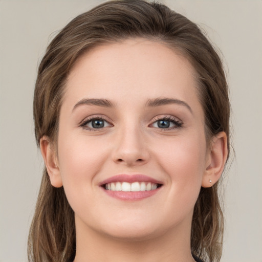 Joyful white young-adult female with long  brown hair and grey eyes