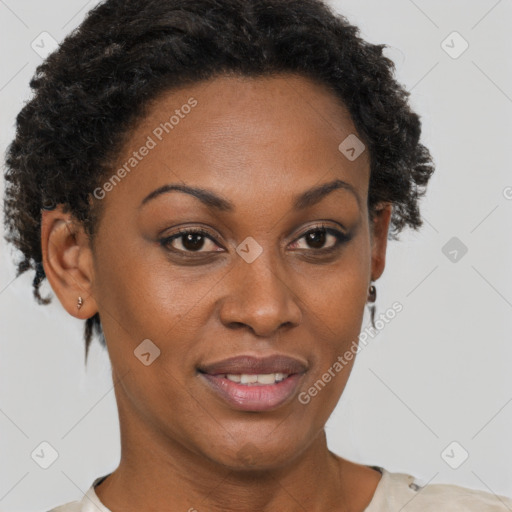 Joyful black adult female with short  brown hair and brown eyes