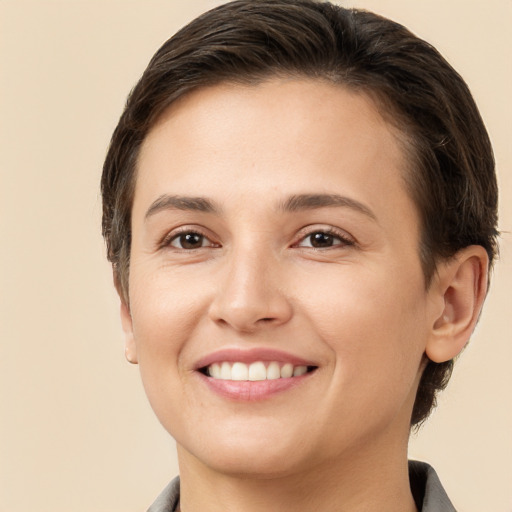 Joyful white young-adult female with short  brown hair and brown eyes