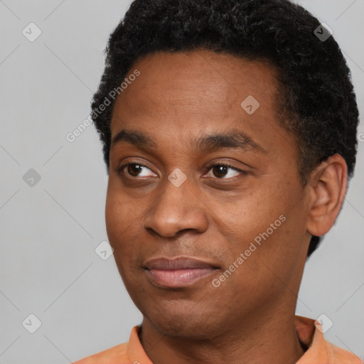 Joyful black young-adult male with short  black hair and brown eyes