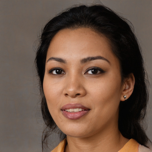 Joyful latino young-adult female with medium  black hair and brown eyes