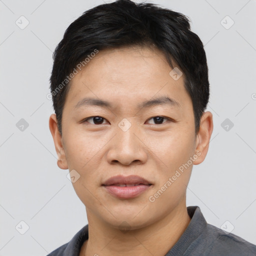 Joyful asian young-adult male with short  black hair and brown eyes